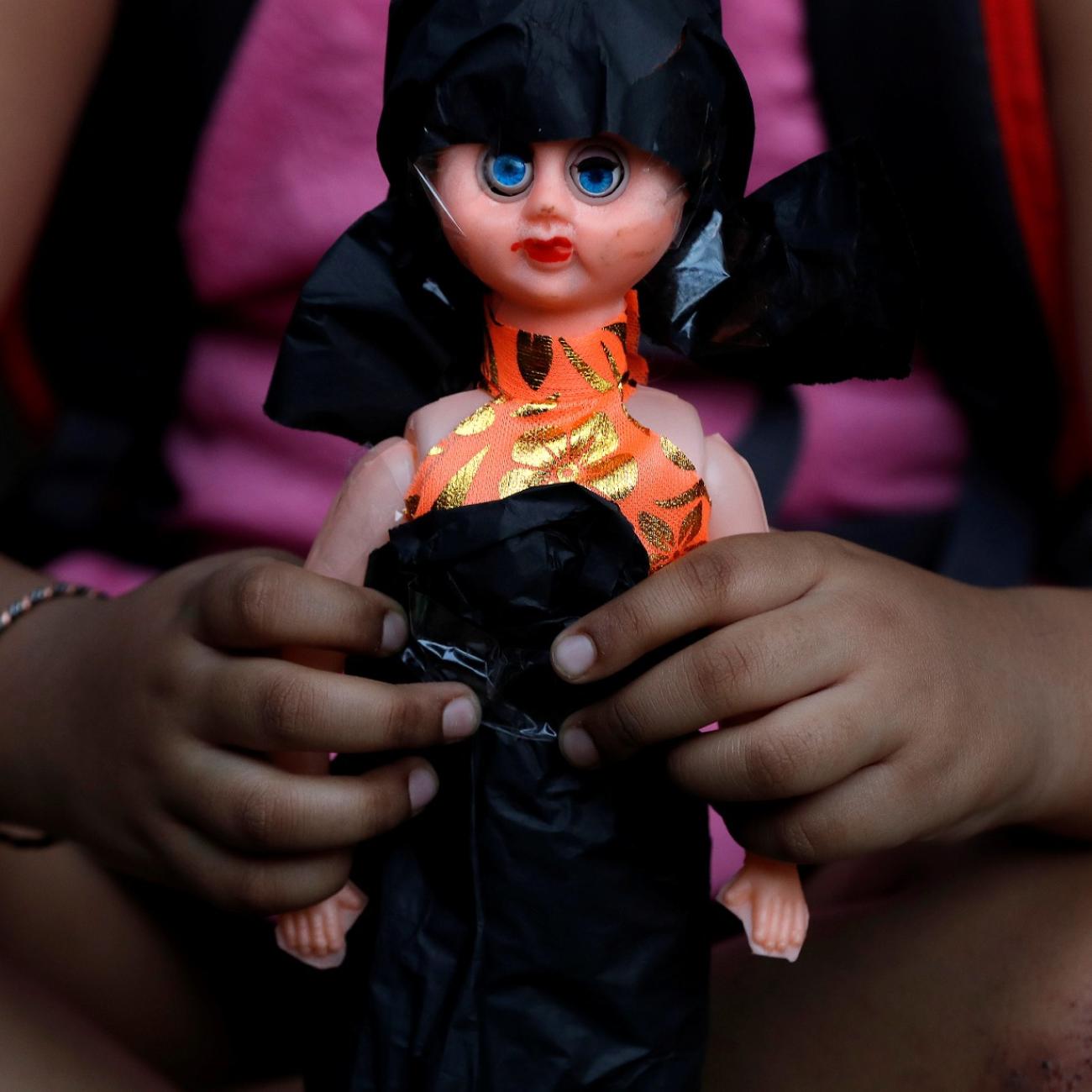 A child attends a protest against the rape of an eight-year-old girl, in Kathua, near Jammu and a teenager in Unnao, Uttar Pradesh state, in New Delhi, India, on April 15, 2018.