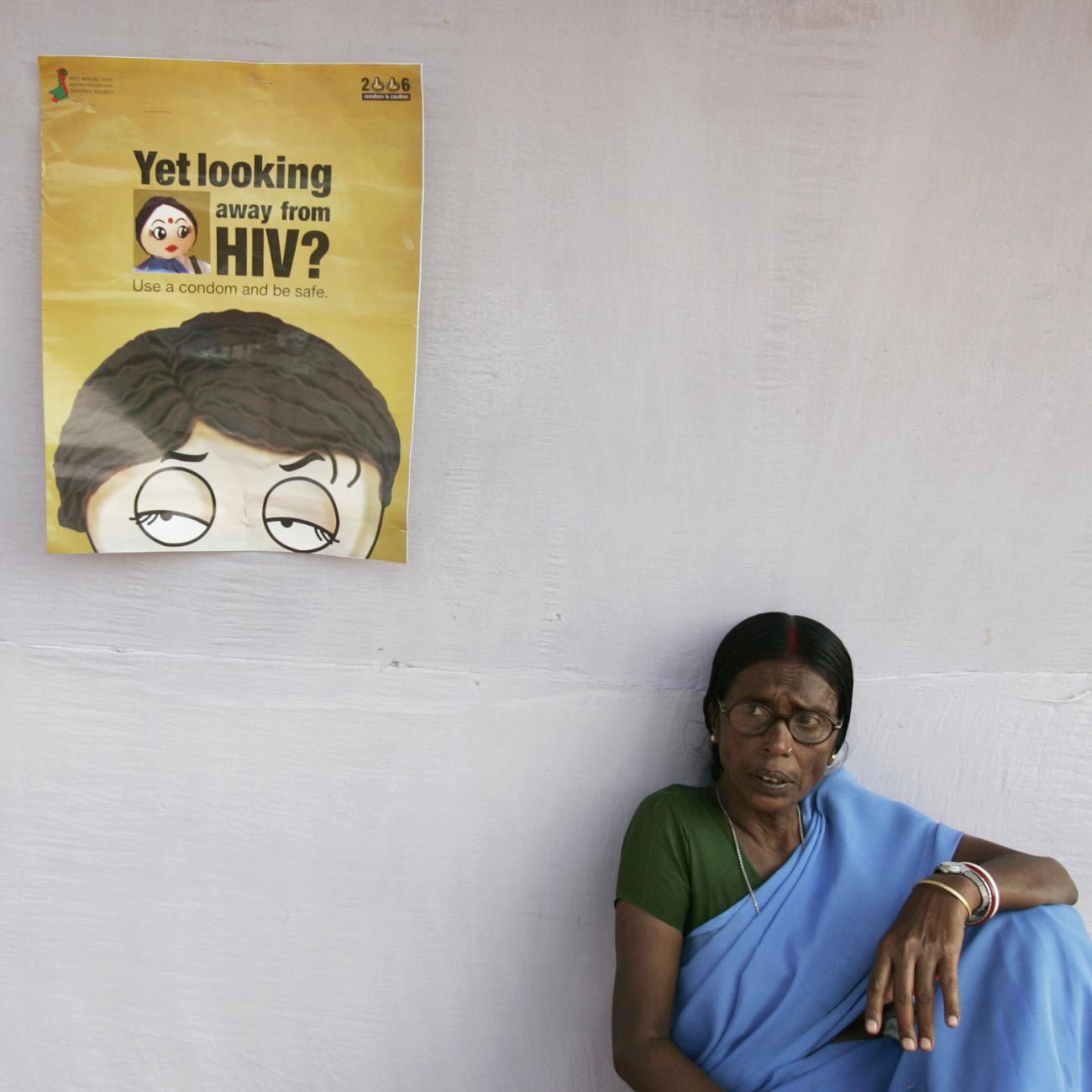 A health worker sits outside a makeshift camp for blood tests on the outskirts of Kolkata, India, on November 30, 2006