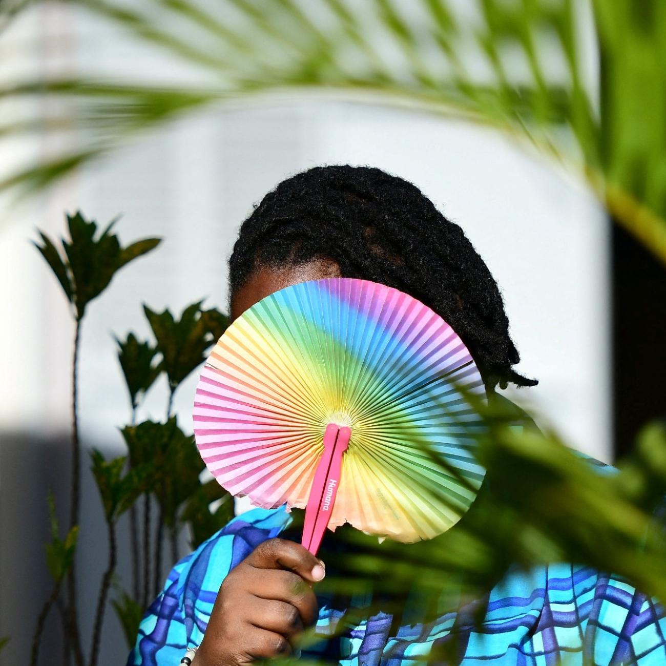 Ashley Karungi 33, a member of the lesbian, gay, bisexual, transgender, intersex and queer (LGBTQ) community and a single mother of two poses for a picture with rainbow colours at the offices of Rella Women's Empowerment Program, for LGBTQ rights advocacy, after a Reuters interview in Kulambiro suburb of Kampala, Uganda April 4, 2023. 