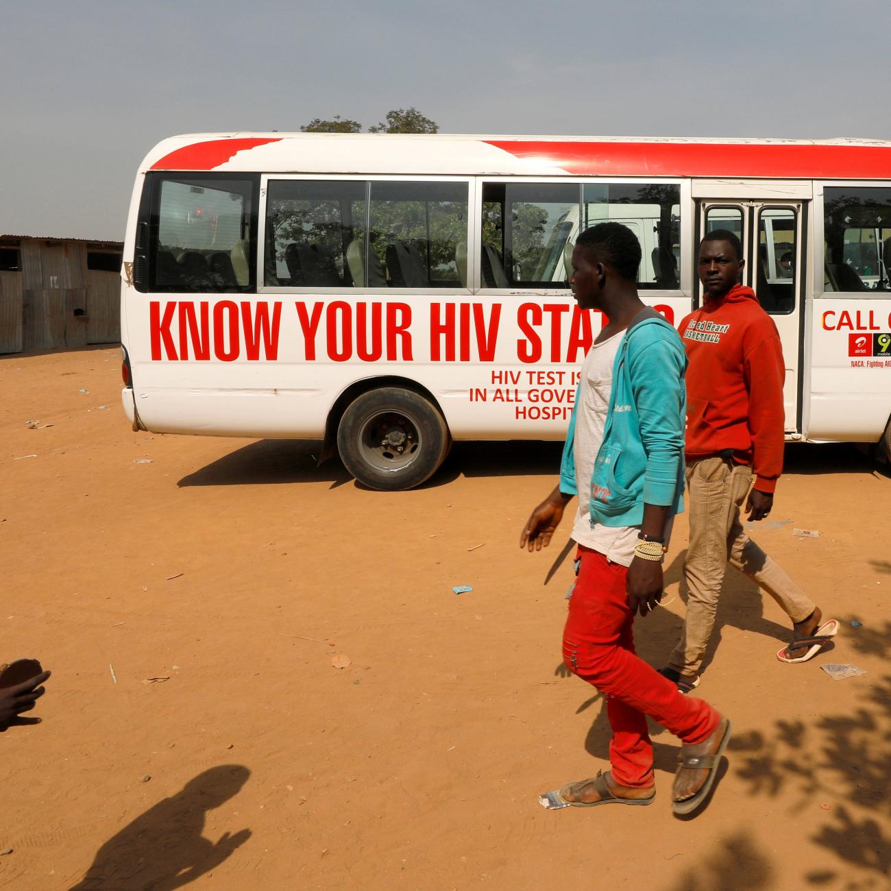 People walk past a bus during an HIV/AIDS awareness campaign on the occasion of World AIDS Day in Abuja, Nigeria, December 1, 2018.