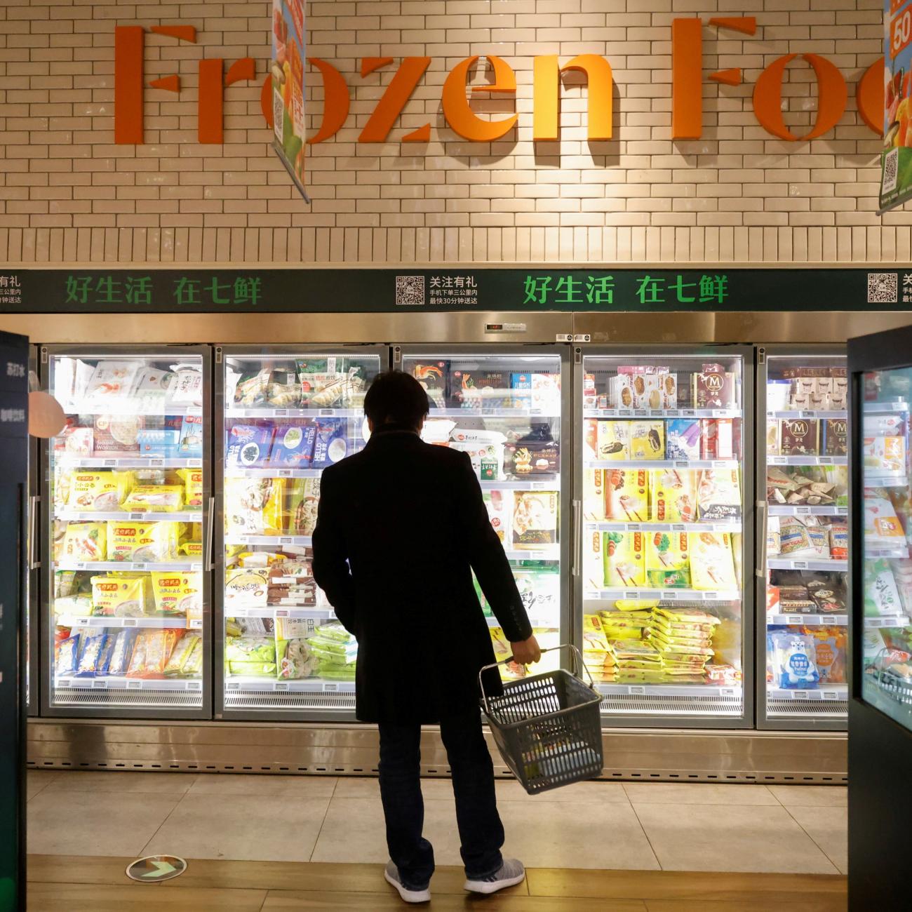 A customer looks at products in the frozen food section at JD's 7Fresh supermarket on China's Singles Day shopping festival during a government organized tour in Beijing, China November 11, 2020. 