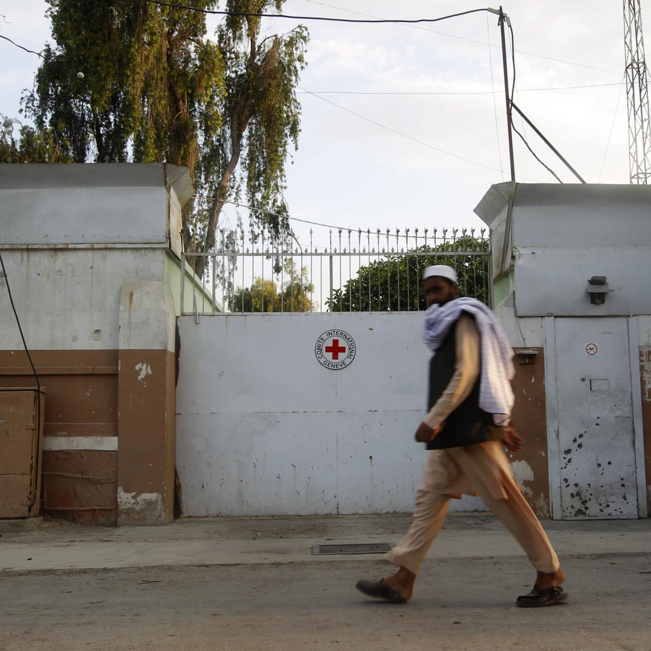 A man walks past the front gate of the International Committee of the Red Cross (ICRC) office in Jalalabad province