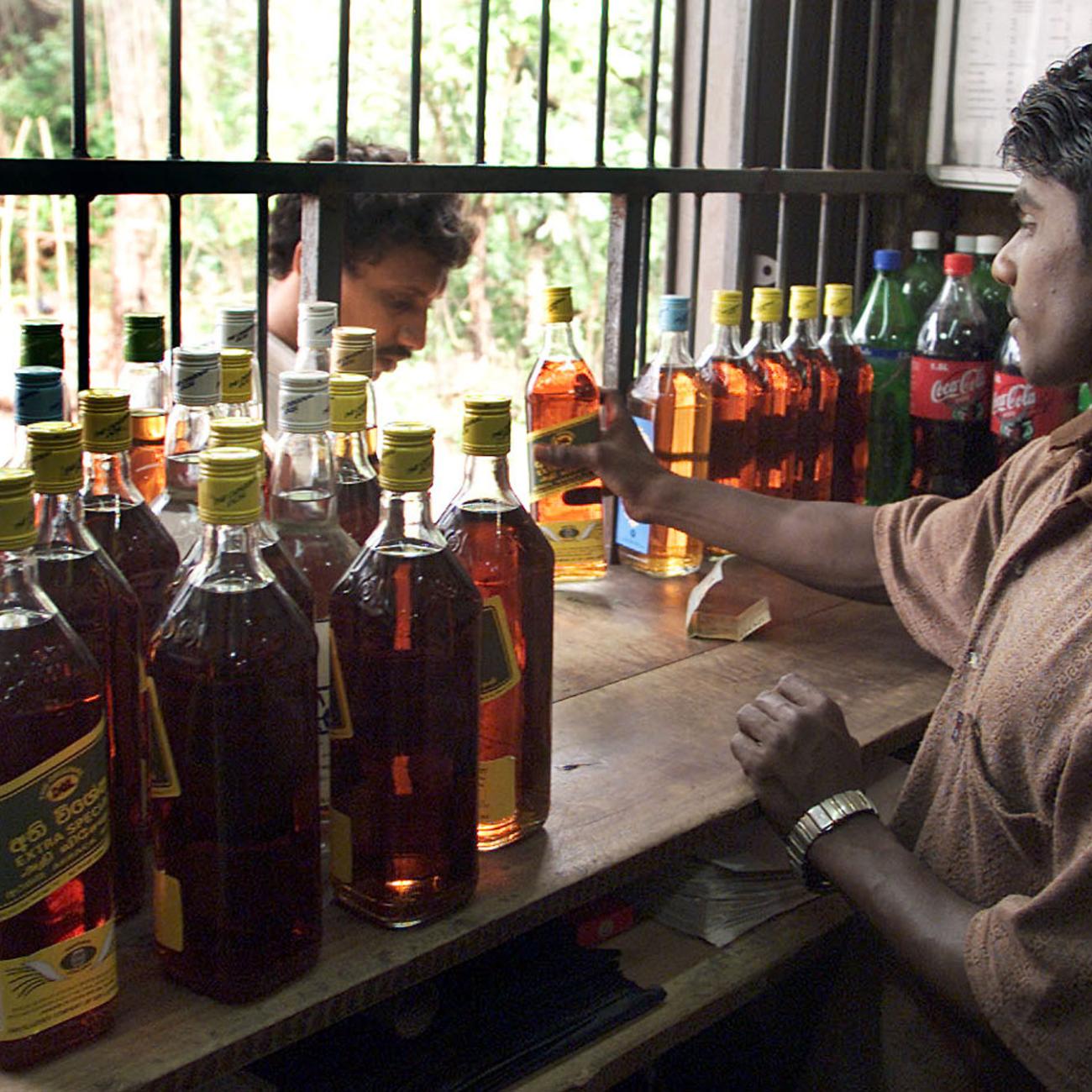 Man selling alcohol from a window.