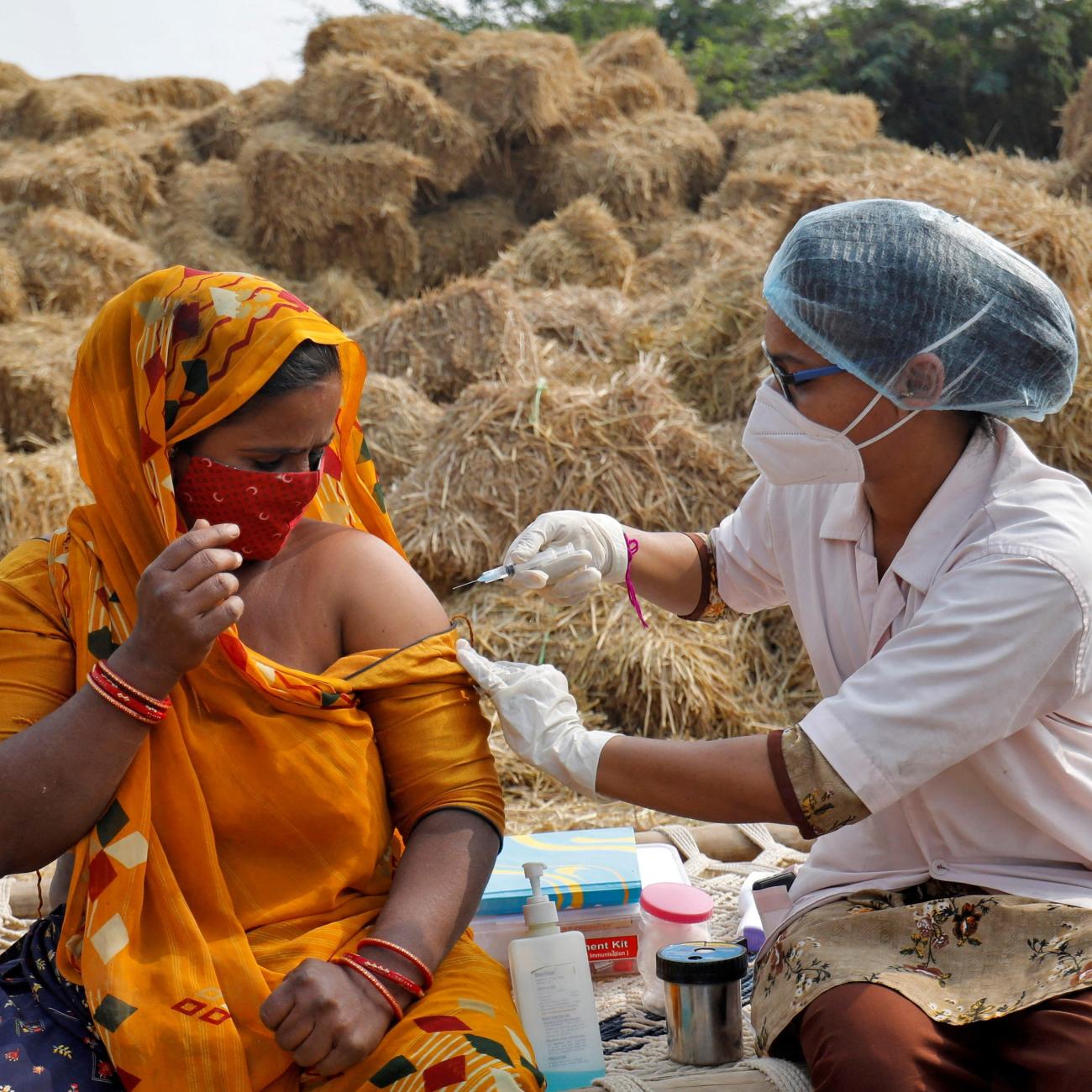 A woman receives a dose of COVISHIELD vaccine against COVID-19, that's manufactured by Serum Institute of India.