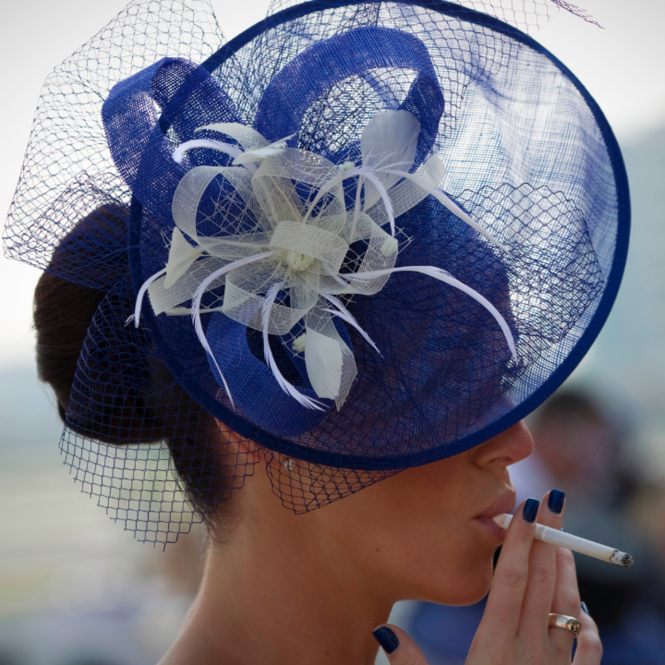 a spectator smokes a cigarette