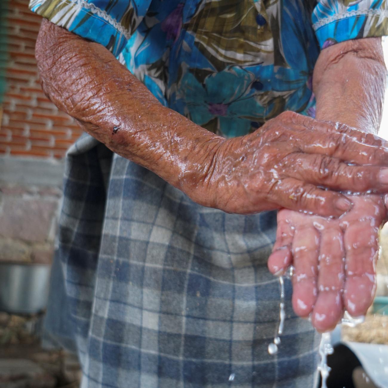 Zapotec woman washes her hands during the COVID-19 pandemic in Oaxaca state, Mexico, on March 31, 2020.