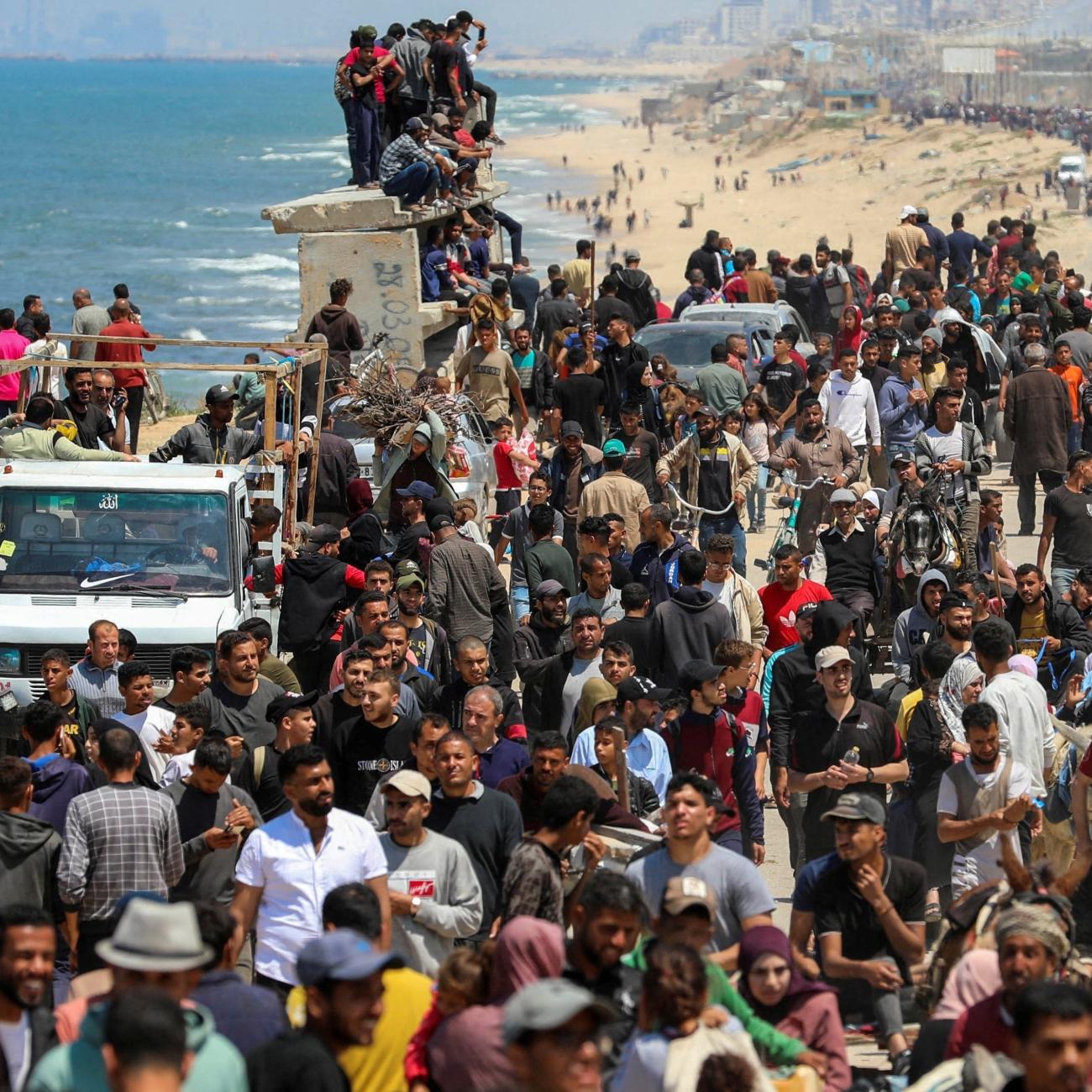 Palestinians, who were displaced by Israel's military offensive on south Gaza, make their way as they attempt to return to their homes in north Gaza.