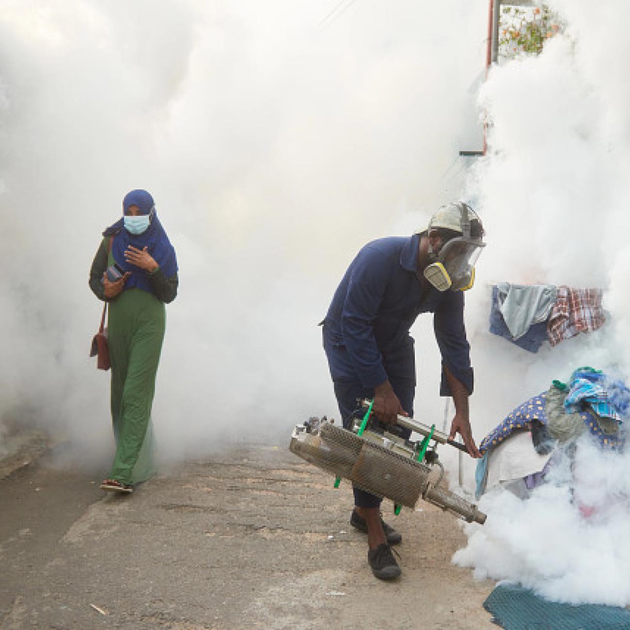 A man fogs the Siddhartha Road neighborhood.