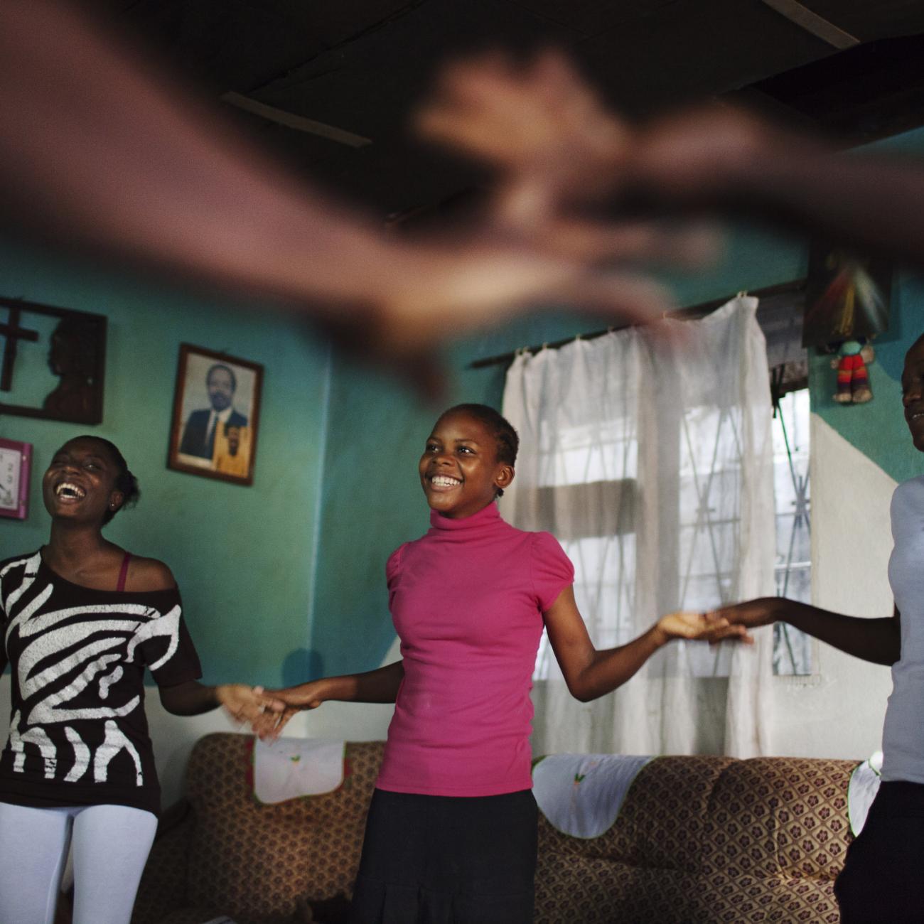 Girls play a clapping game during a weekly education session women’s safety.