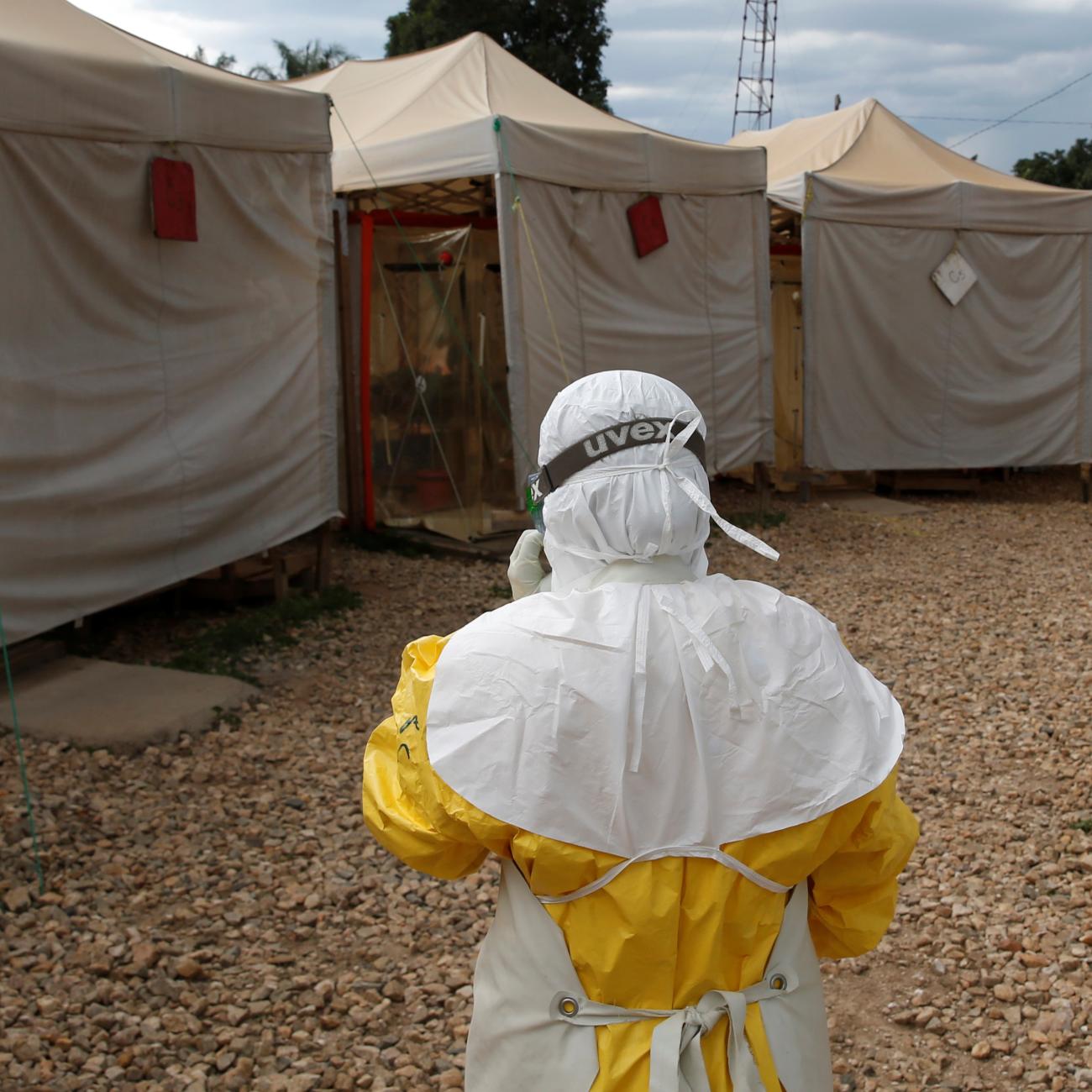 A health worker wearing ebola protection gear, stands outside the Biosecure Emergency Care Unit at the ALIMA Ebola Treatment Center.