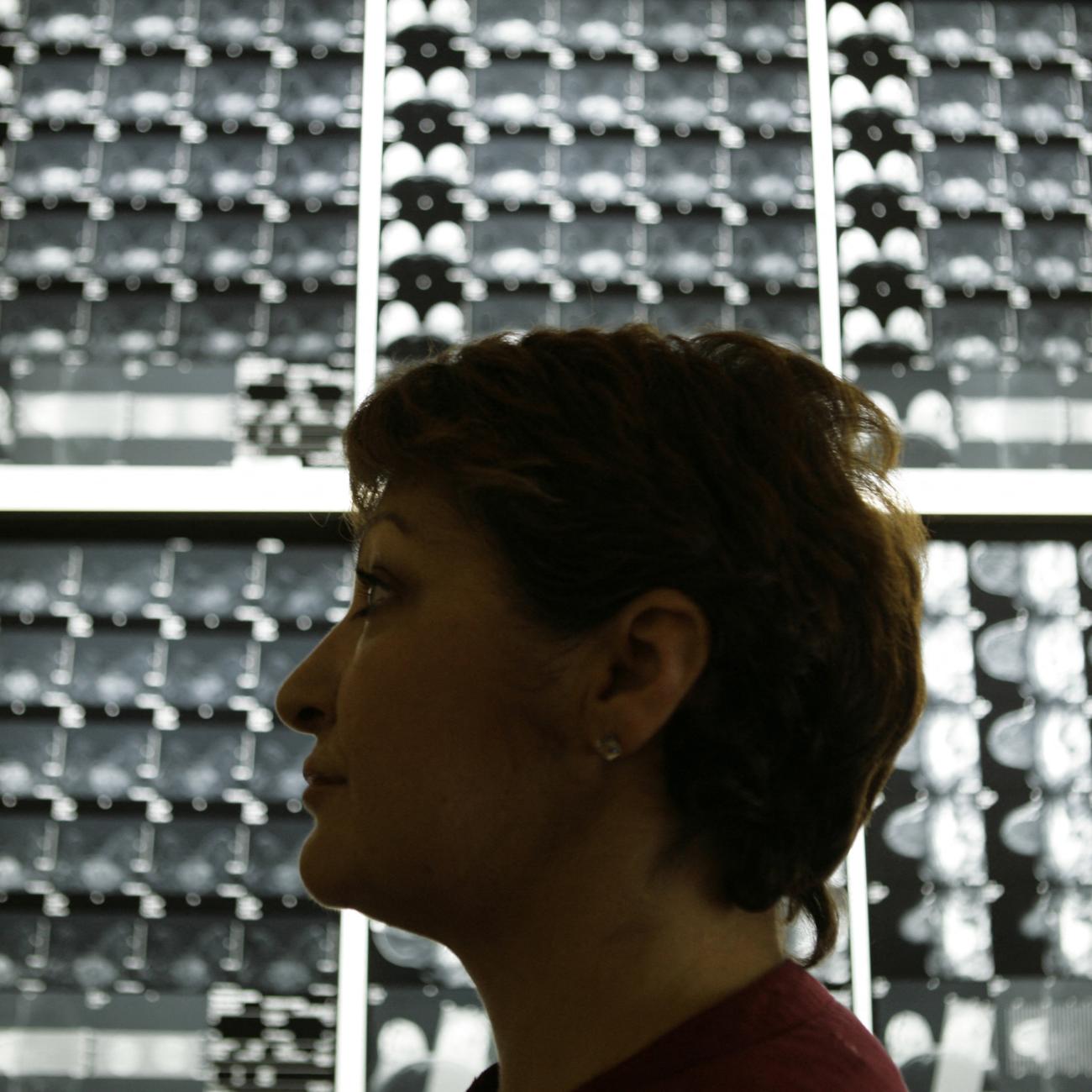 Vasiliki Kostoula, a breast cancer patient, listens to her doctor after a radiological medical examination