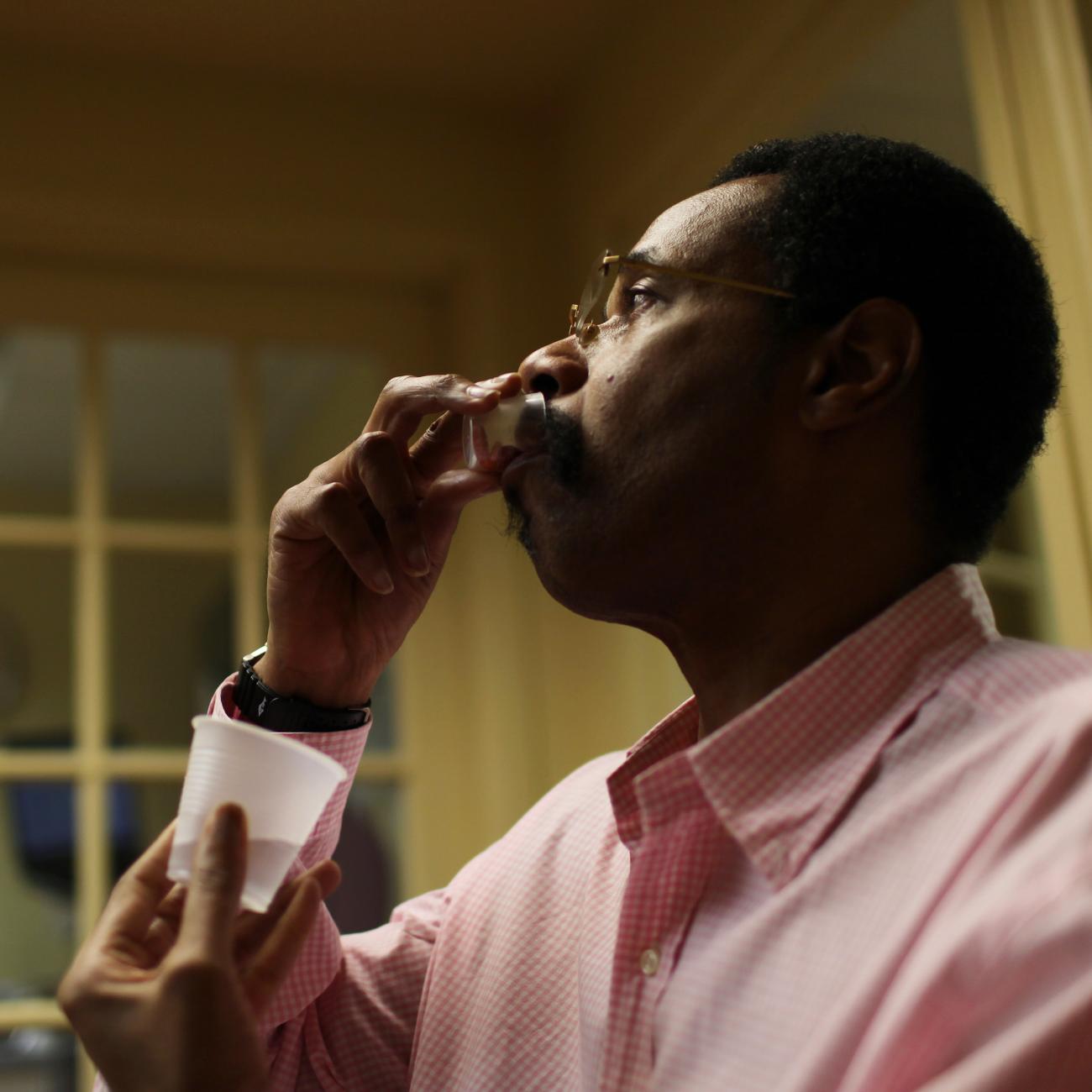 Michael Campbell, 58, receives his daily dose of medication for AIDS at Broadway House for Continuing care