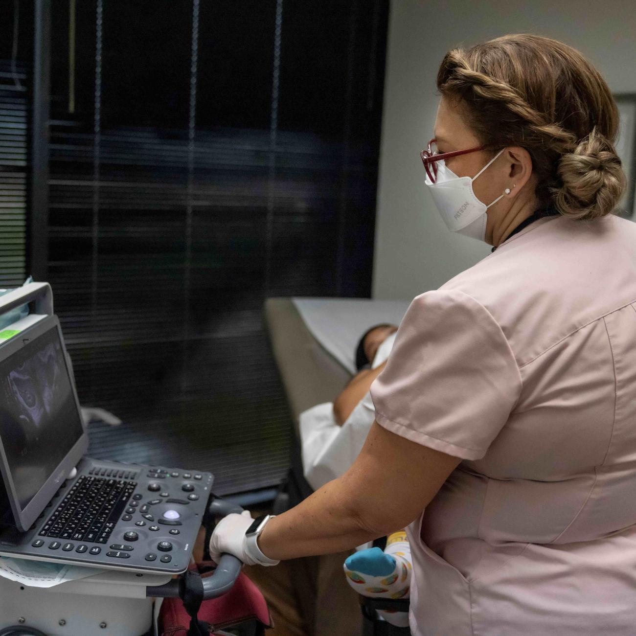 Catalina Leano, a licensed vocational nurse at Houston Women's Reproductive Services, performs an ultrasound with the clinic doctor present.