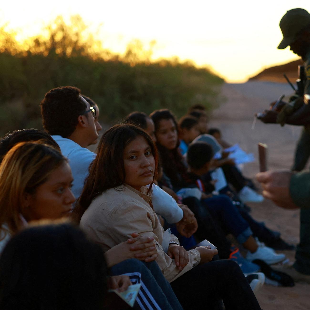 Migrants are detained by U.S. Border Patrol agents after crossing into the United States from Mexico.