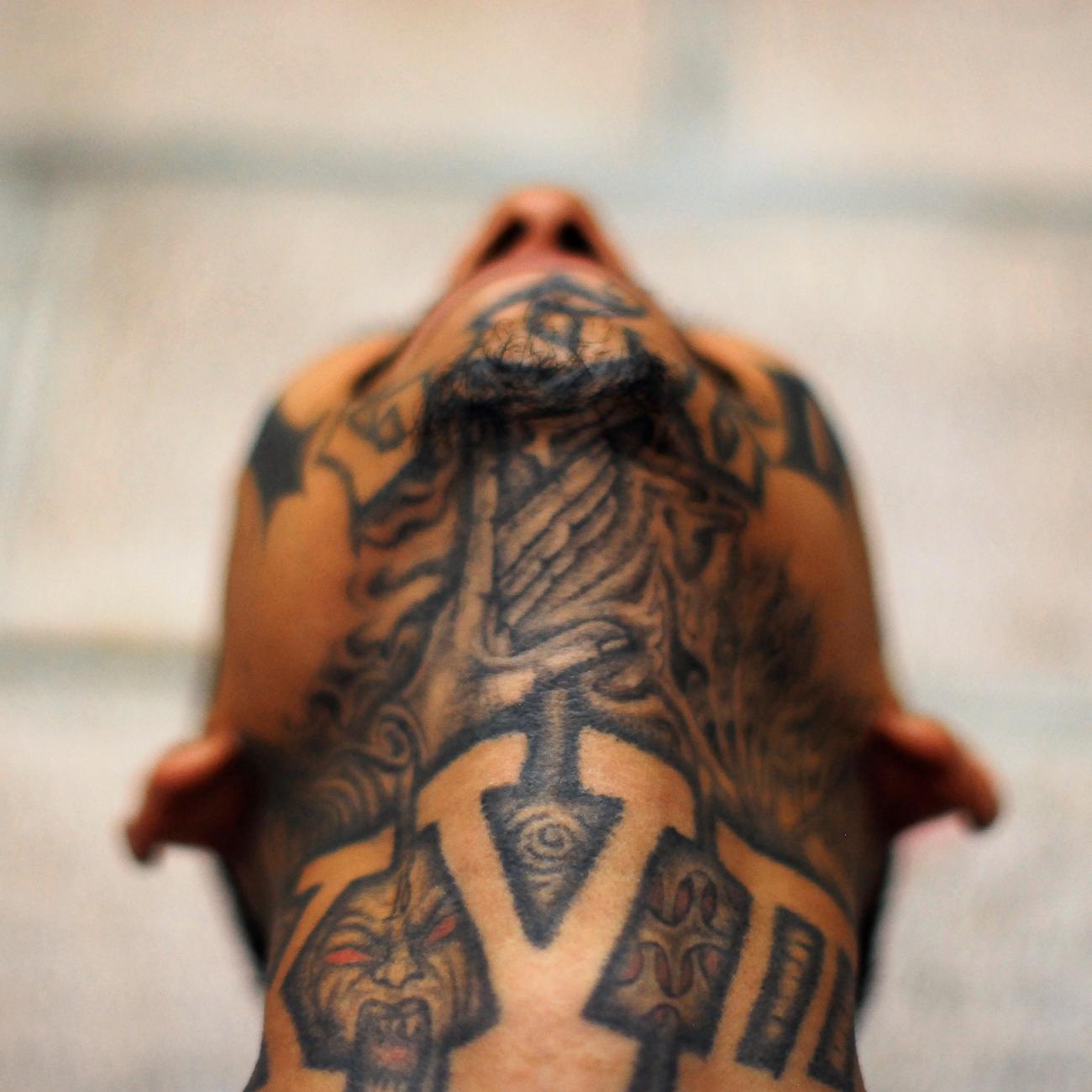 An imprisoned member of street gang Mara 18 poses for a photograph at the Izalco prison.