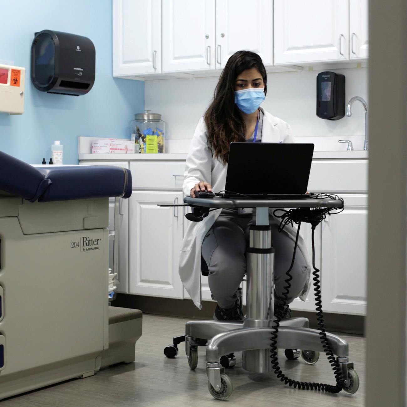 Dr. Meera Shah, the chief medical officer for Planned Parenthood Hudson Peconic, communicates with patients online in an unoccupied exam room in White Plains, New York, U.S., April 3, 2020.