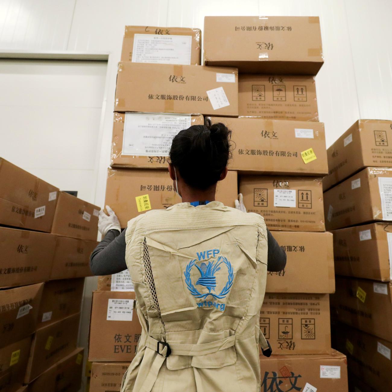 A World Food Program worker arranges relief packages designated to the United Nations for humanitarian aid for Africa to combat the outbreak of COVID-19.
