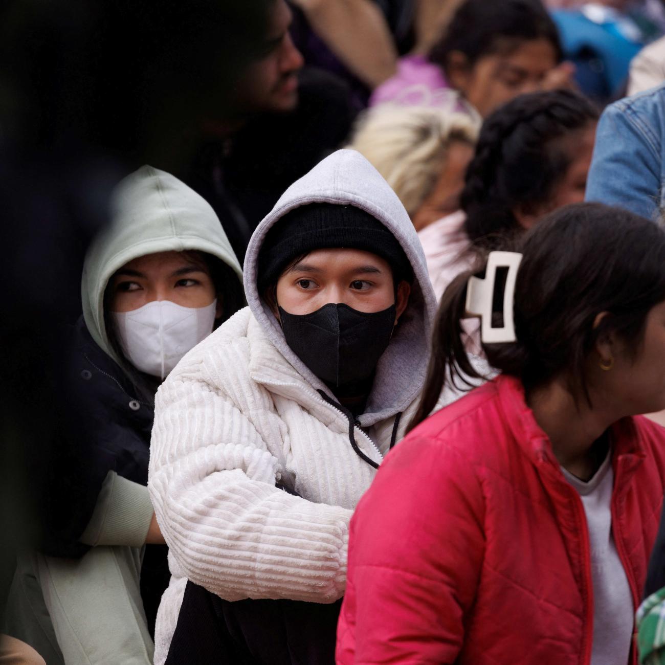 Migrants gather between primary and secondary border fences as the United States prepares to lift COVID-19 era Title 42 restrictions, near San Diego, California, on May 10, 2023. 