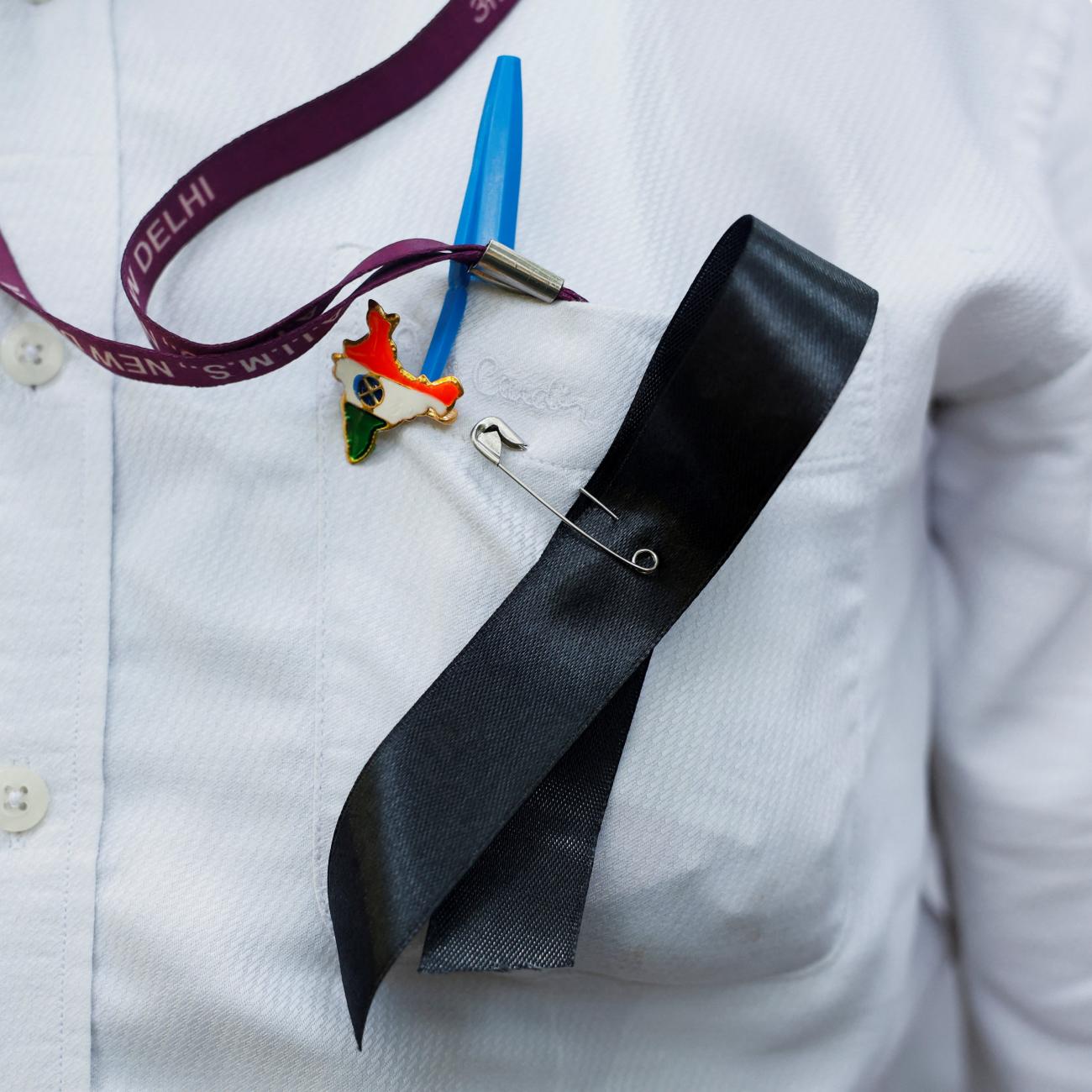 A doctor wears a ribbon and an India map badge on his shirt, during a protest rally demanding justice following the rape and murder of a trainee medic at a hospital in Kolkata, in New Delhi, India, August 16, 2024.