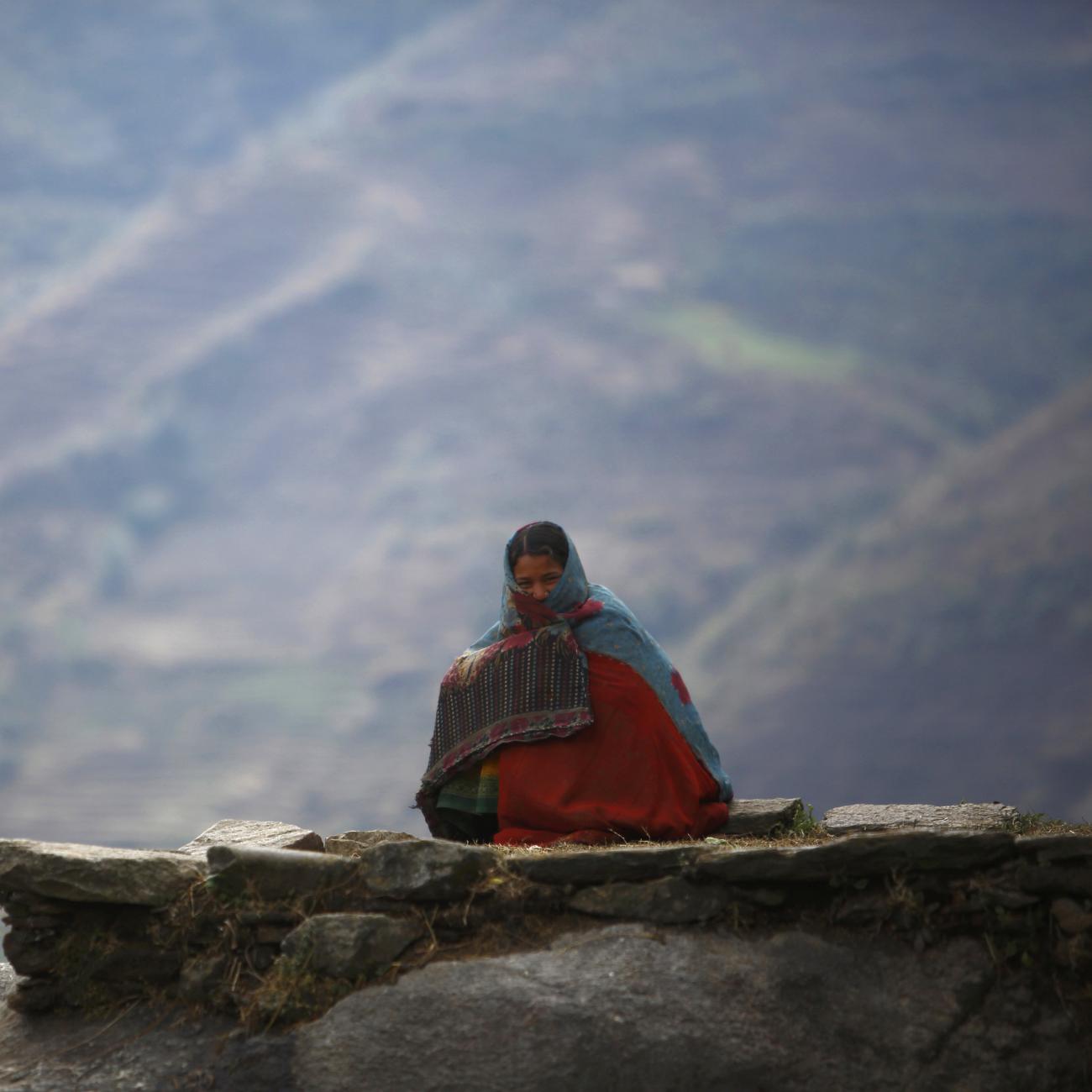 Surja Devi Saud practices Chaupadi outside her house, in Achham District, Nepal, on February 16, 2014. Chaupadi is a tradition observed in parts of Nepal, where women sleep outside while menstruating.