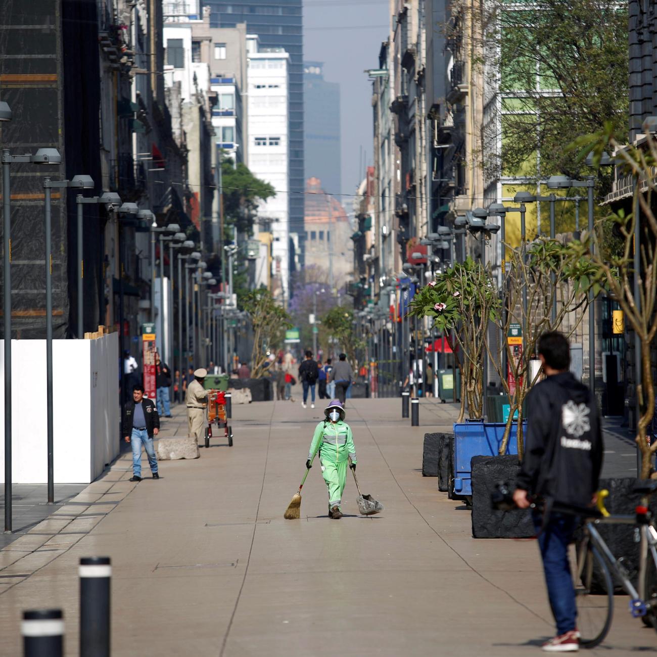 A municipal employee works on an empty street during the COVID-19 outbreak, in Mexico City, Mexico, on March 29, 2020.