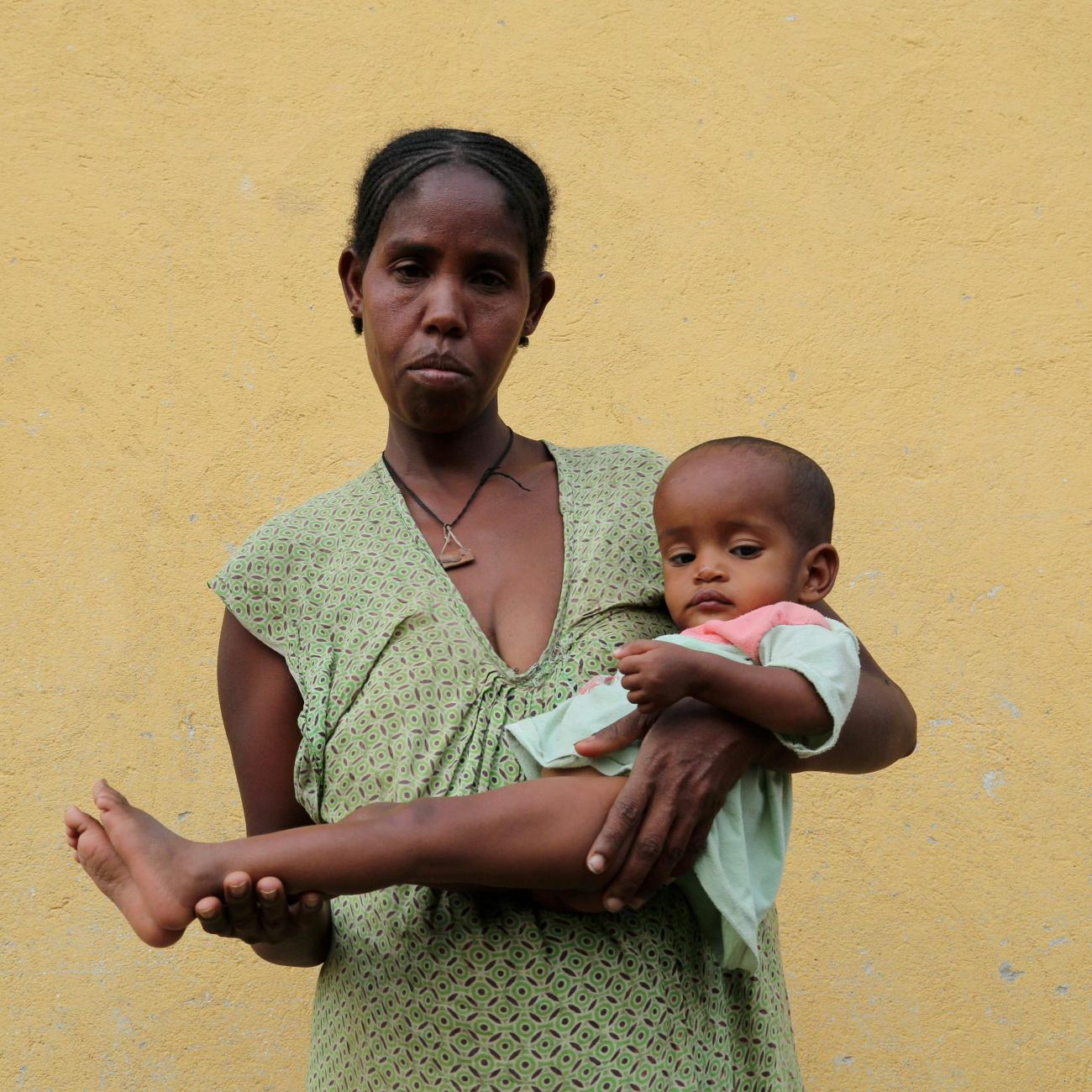 Tsegy Kiday, a 34-year-old displaced single mother of five, holds her 14-month-old daughter Mebrihit Hintsa, in Nebelet, Tigray region, Ethiopia, on July 11, 2021. 