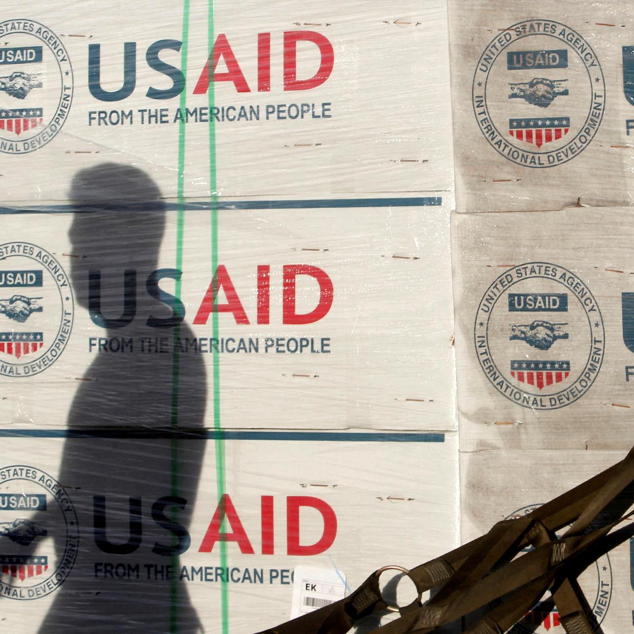 The shadow of a Philippine Army personnel is cast on boxes of relief items from USAID for the victims of super typhoon Haiyan, at Villamor Air Base, in Manila, Philippines, on November 13, 2013. 