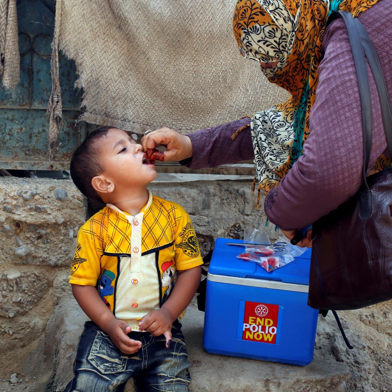 A boy receives polio vaccine drops, during a polio vaccination campaign, in Karachi, Pakistan, on April 9, 2018. 