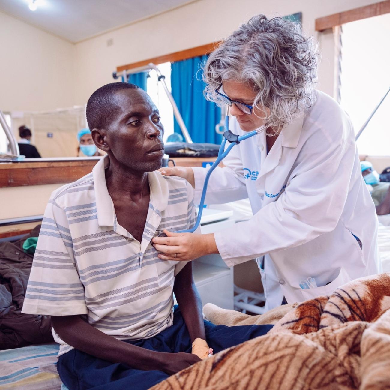 Dr. Stuebing examining a patient who came in for vomiting blood. 