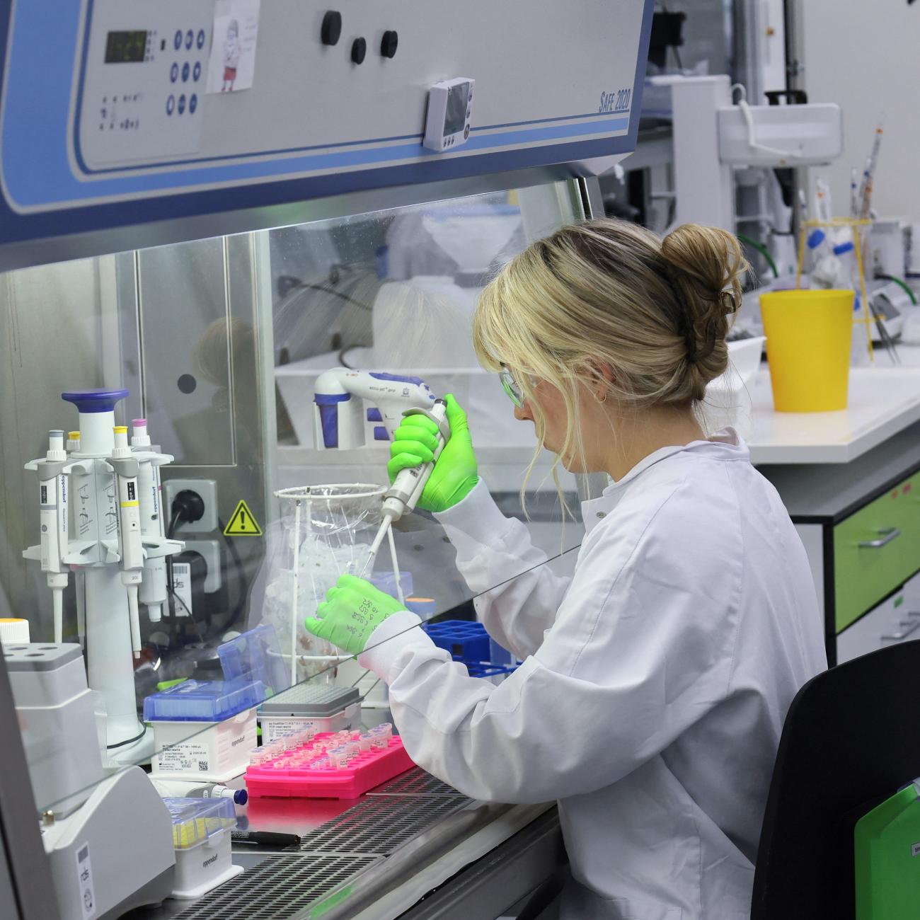 An employee of BioNTtech works at the "Area 100 R&D" research laboratory, in Mainz, Germany, on July 27, 2023. 