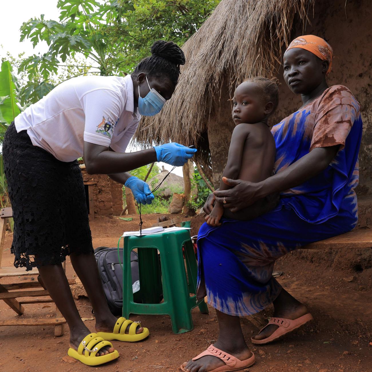 In Uganda’s Bidibidi refugee settlement, a Village Health Team member conducts an in-home health visit to a refugee mother and child. 