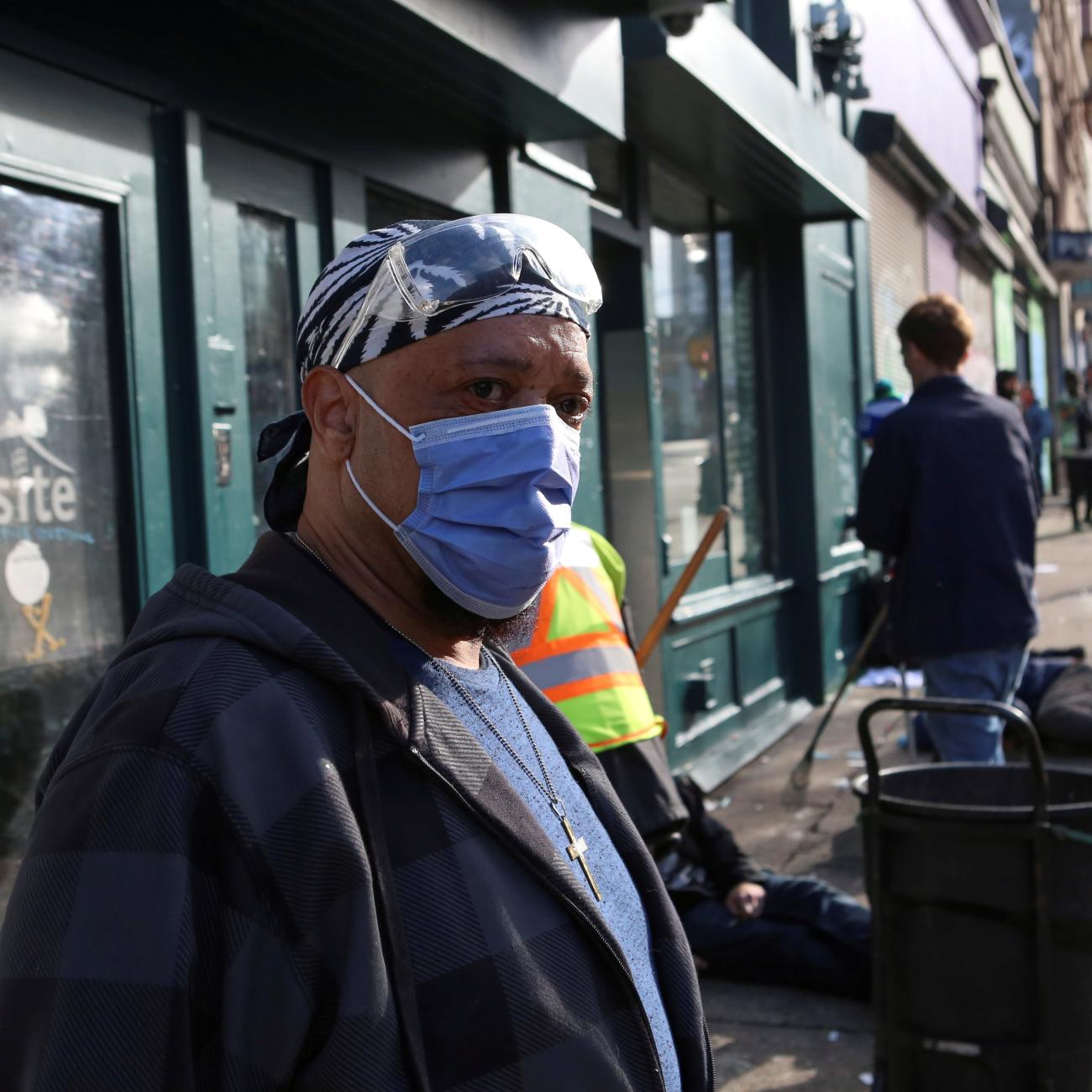 An InSite staff member directs drug users outside the supervised injection site on Hastings Street, in Vancouver, British Columbia, Canada, on March 25, 2020. 