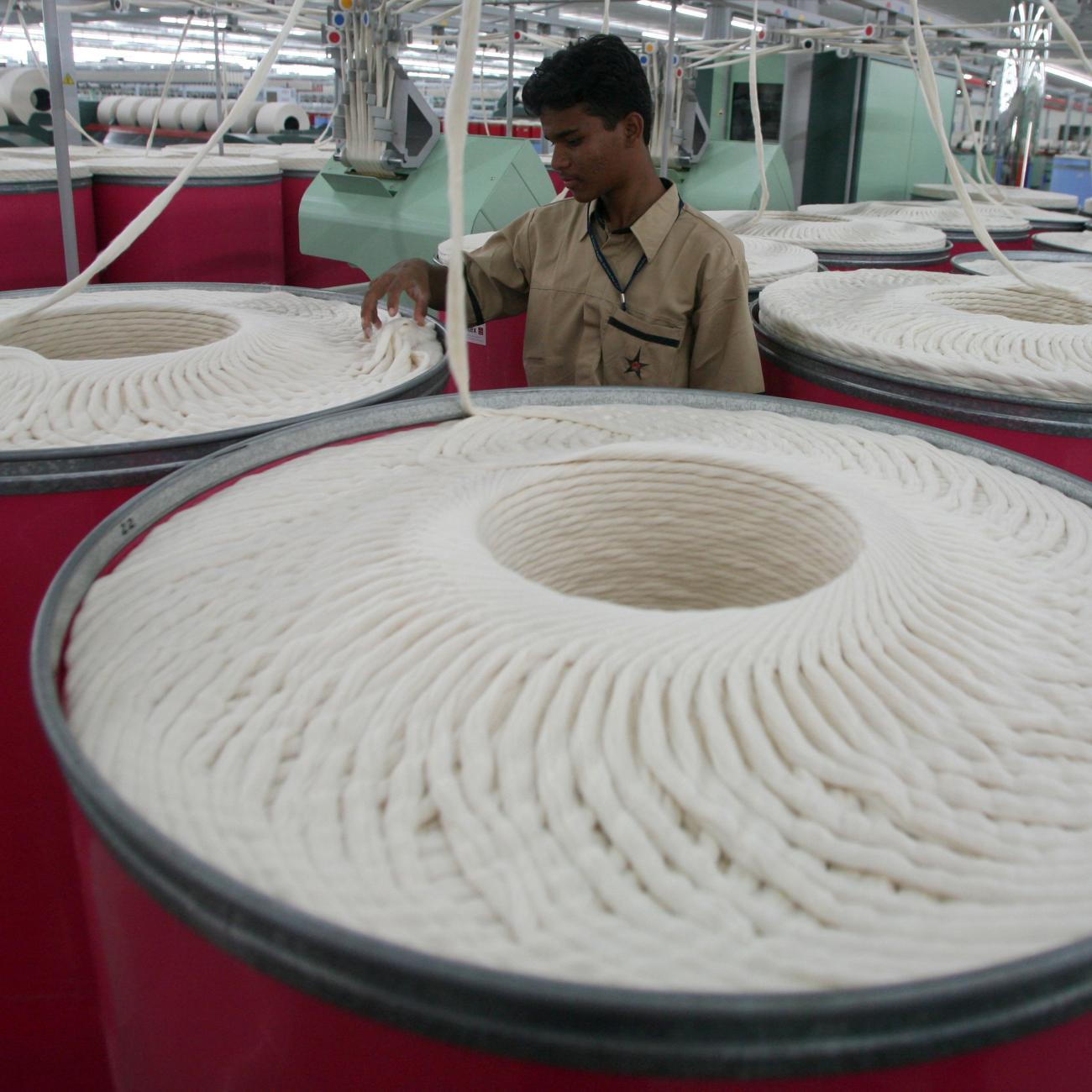 An employee works inside the Century Textiles and Industries Ltd textile mill in Gujarat, India, on October 22, 2009. 