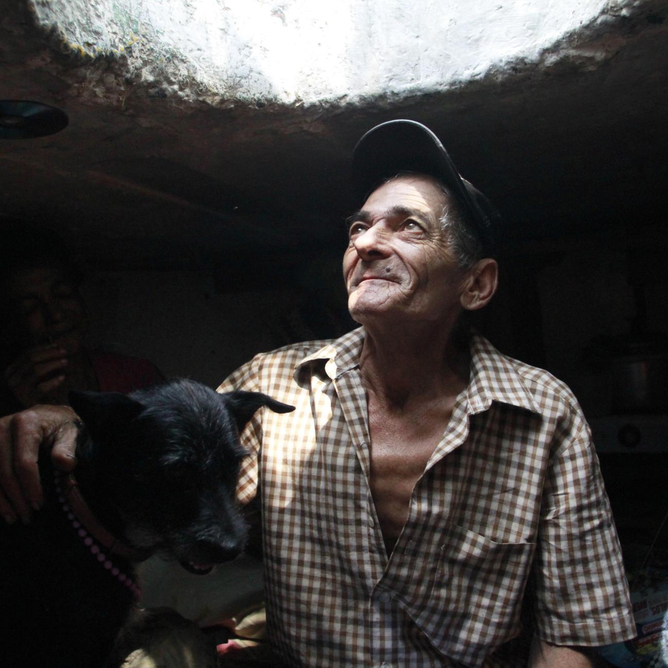 Miguel Restrepo, 62, a former drug addict, looks up from his sewer home in Medellin, Colombia, on December 4, 2012.