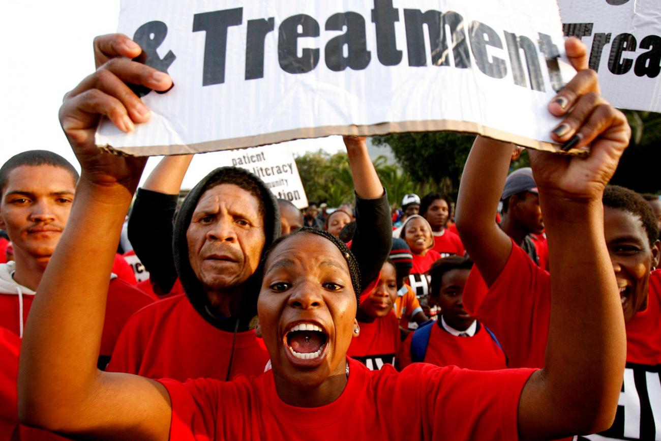 Demonstrators march through the streets of Cape Town to highlight the need for new strategies and medicines to curb the spread of tuberculosis on November 8, 2007. Picture shows a crowd of people wearing red shirts with a woman at center shouting into the camera