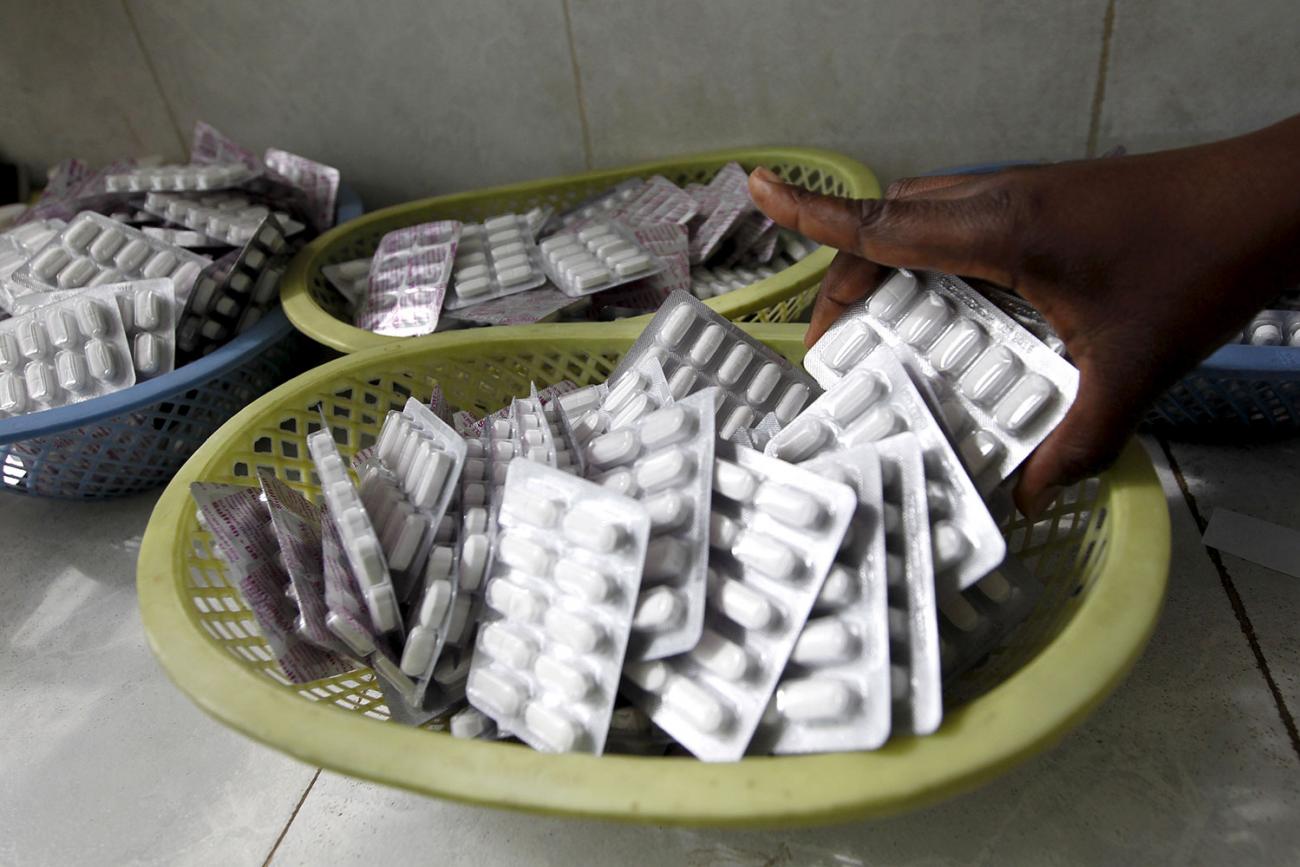 Antiretroviral drugs ready for distribution at the Mater Hospital in Kenya's capital Nairobi on September 10, 2015. Picture shows a hand reaching in and picking up a pack of the pills. REUTERS/Thomas Mukoya