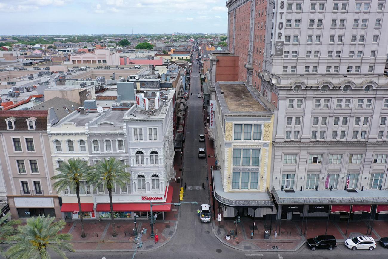 Normally bustling tourist mecca Bourbon Street lies deserted in the early afternoon during shelter in place orders to slow the spread of coronavirus in a photograph of New Orleans on March 27, 2020. The photo shows a view of the entrance to Bourbon street, which would normally be packed with tourists and other people, almost completely empty. REUTERS/Drone Base