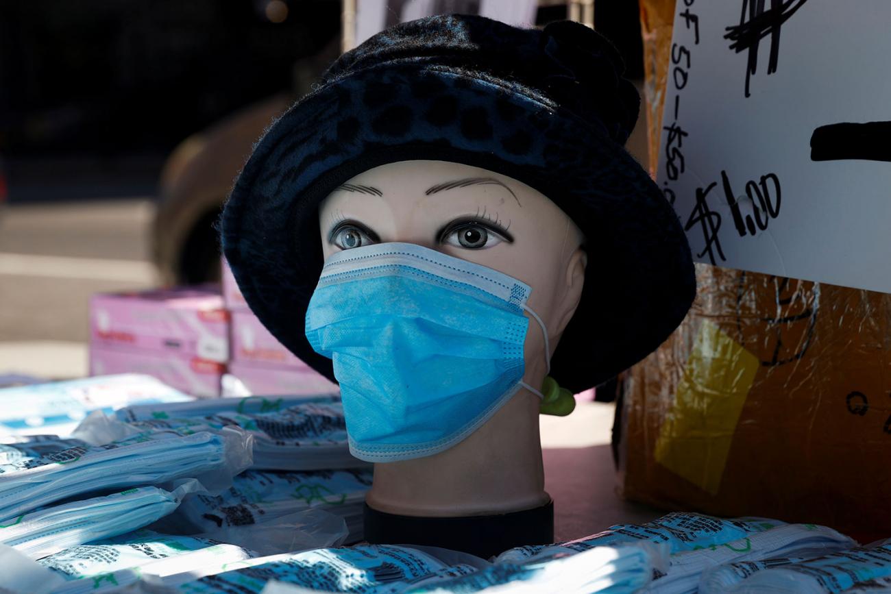 A mannequin with a surgical mask on display where a vendor sells packages of masks on a corner in the Chelsea neighborhood during the outbreak of the coronavirus in New York City on March 27, 2020. The photo shows a mannequin wearing a blue mask. REUTERS/Mike Segar