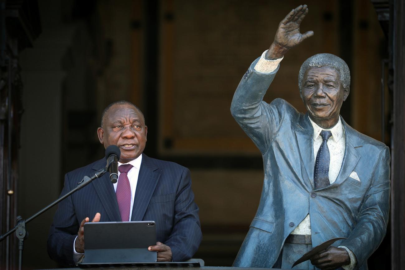 South Africa's President Cyril Ramaphosa speaks in Cape Town, South Africa on Feb 11, 2020 from the balcony where, 30 years before, Nelson Mandela gave his first speech after his release from prison. The images shows the president standing next to a life-sized statue of Nelson Mandela. REUTERS/Sumaya Hisham