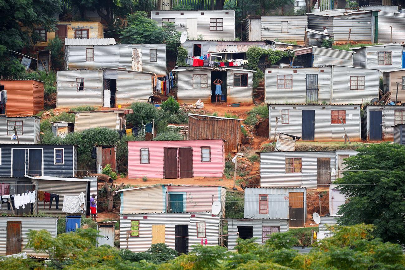 A general view of shacks during a nationwide twenty-one day pandemic lockdown in an attempt to contain coronavirus infections in Umlazi township near Durban, South Africa, on March 31, 2020. The photo shows a hillside covered with tin shacks, some colorfully painted. REUTERS/Rogan Ward 