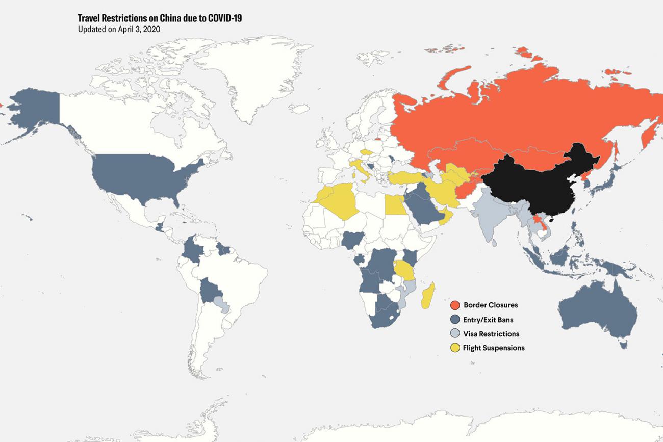 The image is a map of the world showing different countries colored different hues based on four levels of travel restrictions. 