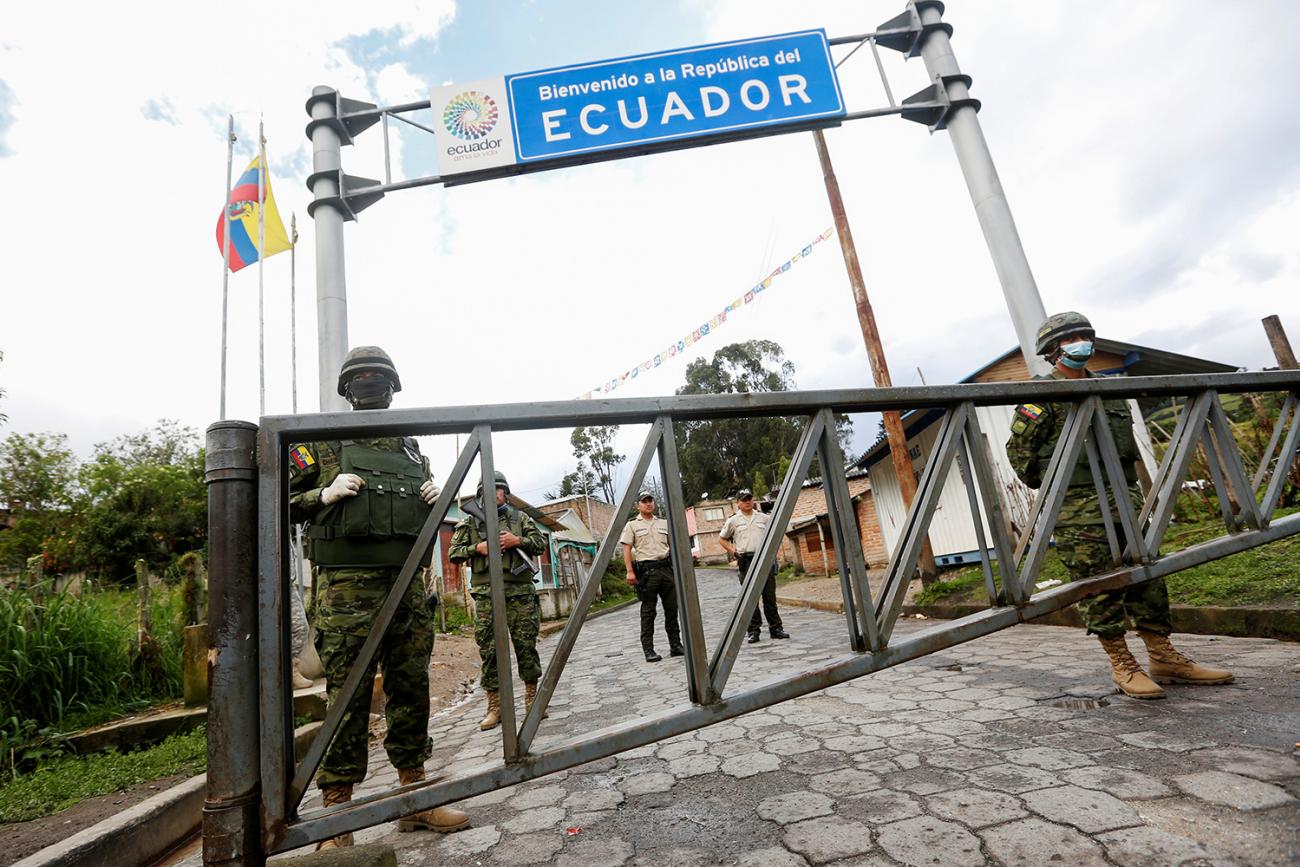Soldiers on the Ecuadoran side of the border with Colombia, in Tufino, Ecuador, after their government announced the closure of borders to all foreign travelers due to coronavirus on March 15, 2020. The photo shows a border crossing with a large sign reading, Ecuador, and several soldiers in the frame. REUTERS/Daniel Tapia