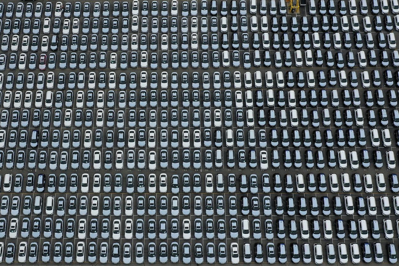 New cars are seen lined up next to the dock as the global outbreak of the coronavirus disease (COVID-19) continues, at the Port of Los Angeles, California, U.S., April 29, 2020. The photo is an aerial shot of a large lot packed completely with lines of cars. REUTERS/Lucy Nicholson