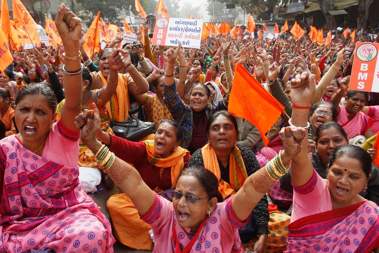 Anganwadi center workers at a protest rally in Ahmedabad, India, on December 24, 2013. There are more than 1.3 million such centers in India with three million workers. The proto shows a huge crowd, nearly all women, shouting and protesting at a crowded rally. REUTERS/Amit Dave