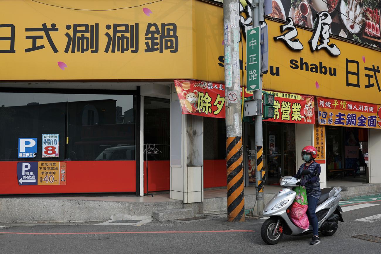 Taoyuan health worker Wang Tsui-lien rides a scooter to deliver care packages and to check on people who have been ordered to be under self-quarantine, in Taoyuan, Taiwan, on March 25, 2020. Photo shows a motorcycle on an abandoned street in an urban setting. REUTERS/Ann Wang