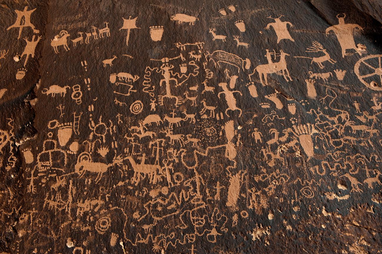 Hundreds of petroglyphs cover Newspaper Rock, in Bears Ears National Monument, Utah, next to the Naajo Nation, on October 29, 2017. The photo shows a dark rock face covered with hundreds of carved depictions of humans and animals. REUTERS/Andrew Cullen