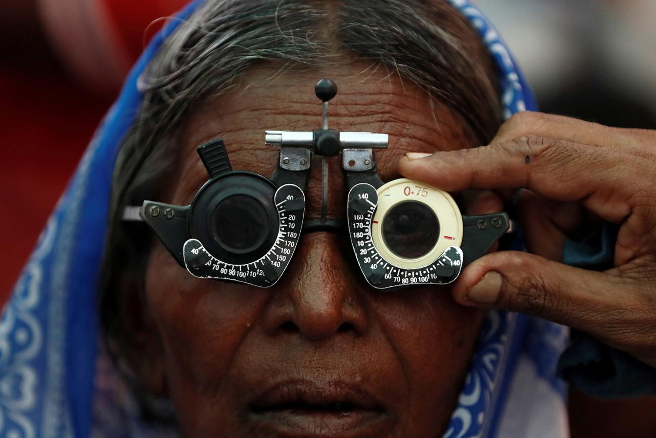 A woman gets her eyes tested at a free eye-care camp on the occasion of Indian politician Babasaheb Ambedkar's death anniversary in Mumbai, India, December 6, 2019. The photo shows an older woman with testing glasses on her face. REUTERS/Francis Mascarenhas 
