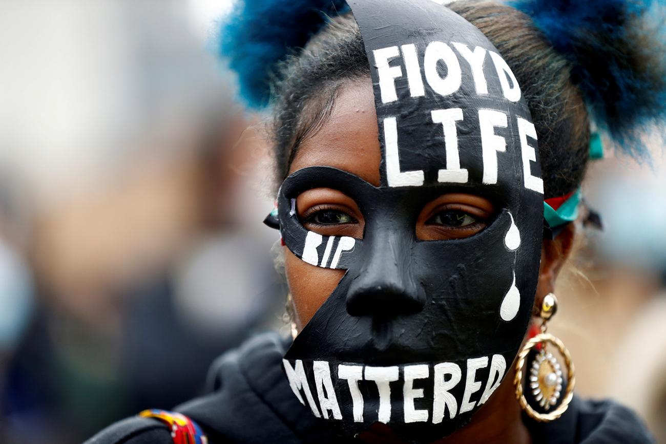 A woman wears a mask during a Black Lives Matter protest in Centenary Square in Birmingham, England following the death of George Floyd who died in police custody in Minneapolis, on June 4, 2020. The picture shows a woman in a striking mask adorned with the words Floyd Life "Mattered." REUTERS/Jason Cairnduff 