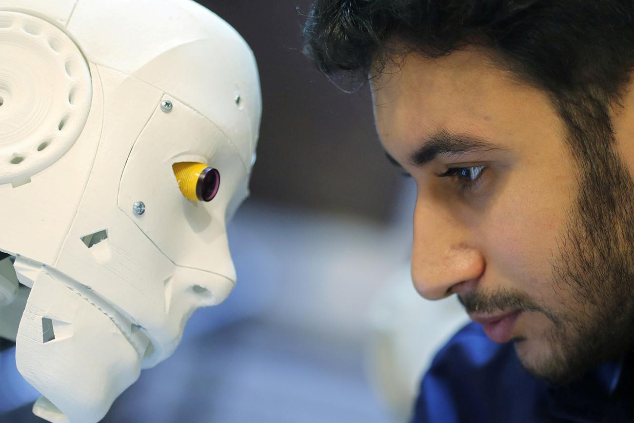 The remote-controlled robot built by Egyptian mechanical engineer Mahmoud El komy to test people for coronavirus by running PCR tests, limiting exposure to suspected cases, is pictured in Cairo, Egypt, on June 12, 2020. Picture shows the robot and inventor eye-to-eye. REUTERS/Mohamed Abd El Ghany