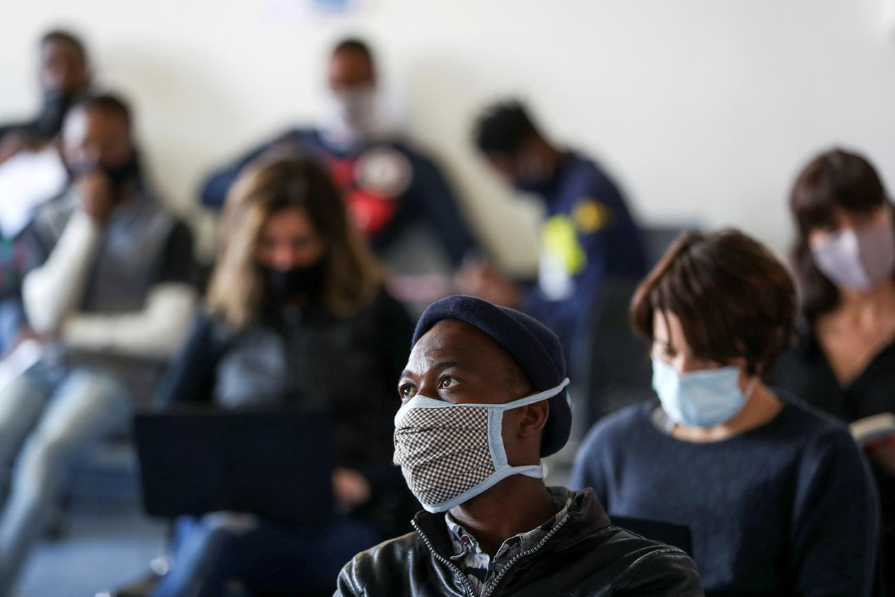 Volunteers wait for their names to be called before testing and taking part in a COVID-19 clinical trial at the Wits RHI Shandukani Research Centre in Johannesburg, South Africa, on August 27, 2020. Picture shows a waiting room full of people. REUTERS/Siphiwe Sibeko